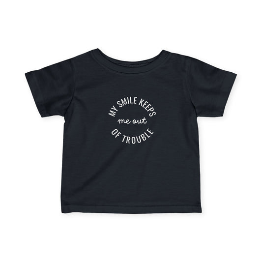 Infant Tee — “My Smile Keeps Me Out of Trouble” Funny Baby Graphic Shirt